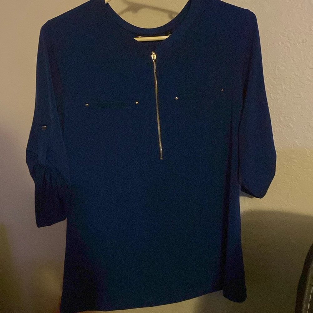 Dark blue womens quarter length sleeve top.Buttons on sleeve to button up.